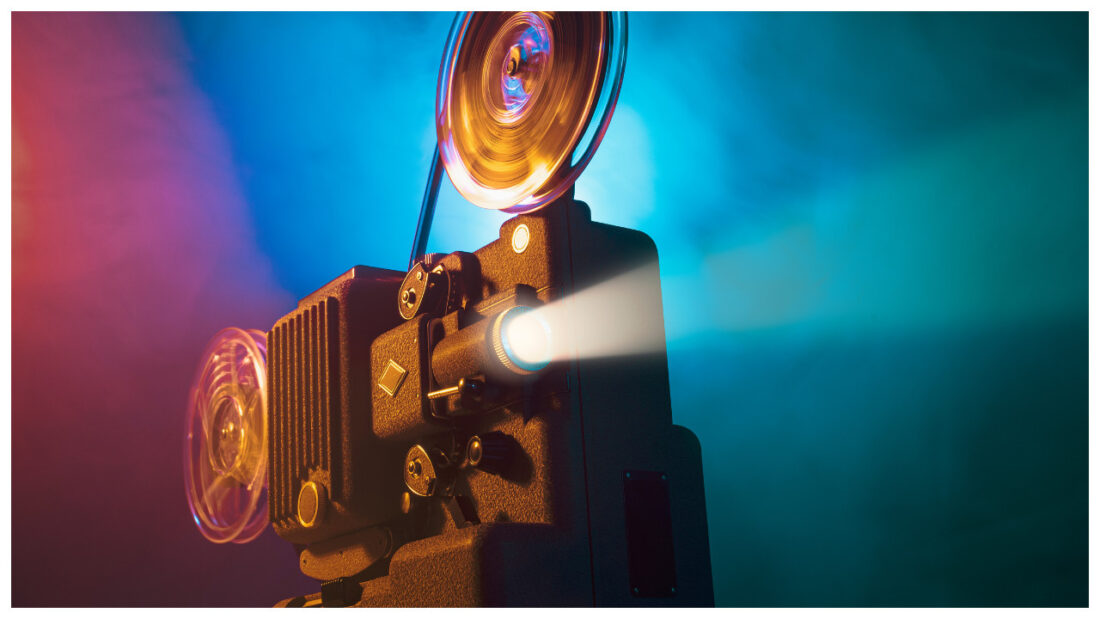 Projector in a dark room screening a film