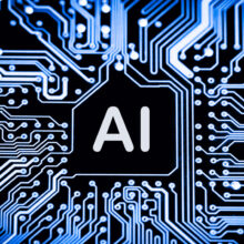 Close-up of a circuit board with glowing blue pathways. The central processing unit is labeled "AI" in bold white letters.